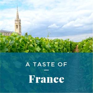 A vineyard with a cathedral in the background. Text: Taste of France